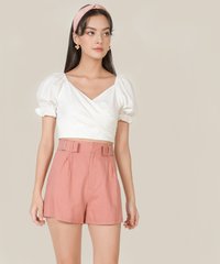 Model wearing Viola linen buckle shorts in rose pink colour