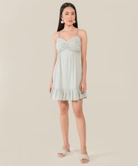 model standing in ruffle dress in blue