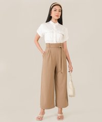 model wearing caville cuff sleeve blouse in white and wide leg pants