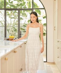 model wearing white floral embroidered maxi dress looking down