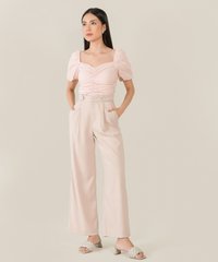 model wearing rosé ruched cropped top and wide leg pants in pale pink