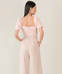 model wearing rosé ruched women's cropped top back view