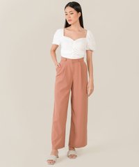 model wearing rosé ruched women's cropped top in white and wide leg pants