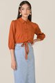 model in elm striped texted blouse in burnt orange and denim midi skirt
