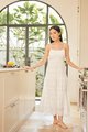 model wearing white floral embroidered maxi dress at home kitchen