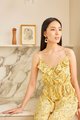 model sitting in resa abstract floral ruffle jumpsuit in daffodil colour