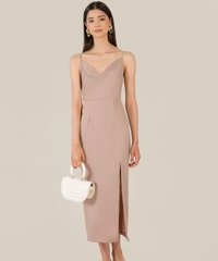 model in dolce cowl neck women's midi dress in taupe carrying bag