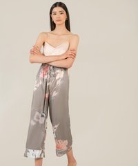 model cross arms in satin pink camisole and akin olive grey floral satin pants