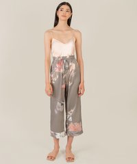 model standing in satin pink camisole and akin olive grey floral satin pants