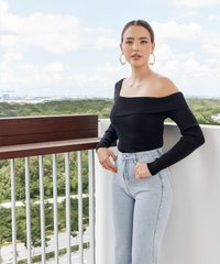 Model wearing Karine Cold Shoulder Knit Top in Black